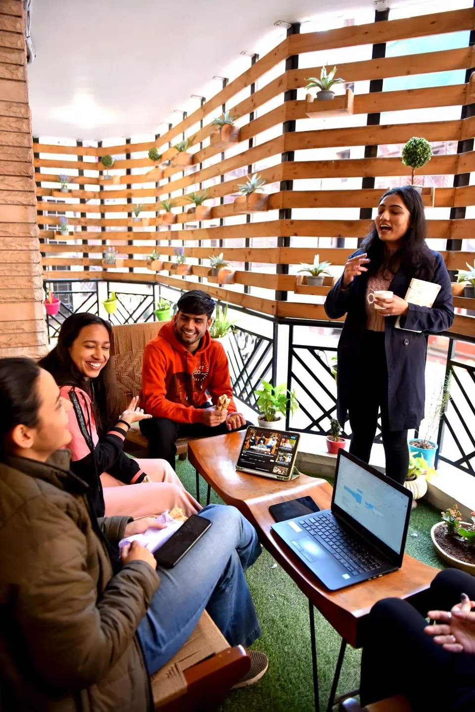 Members chatting on the green balcony at CollaboCorner, Jaipur